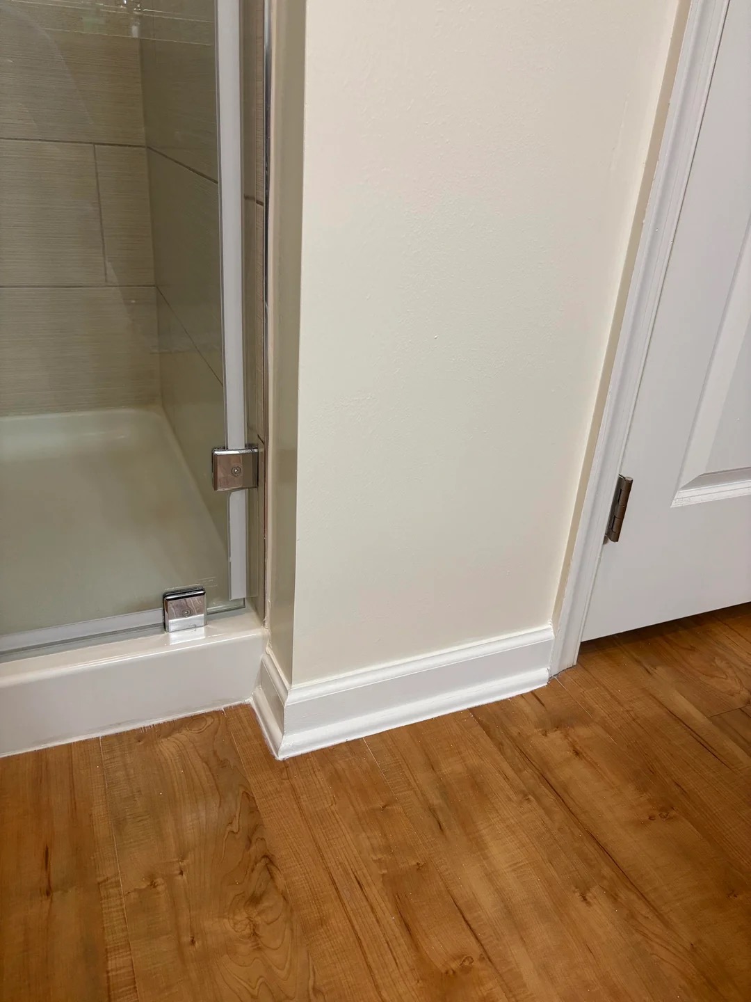 Finished drywall repair at a shower and doorway corner