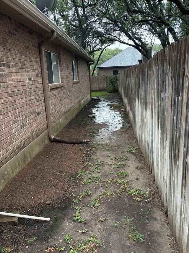 Wet San Antonio side yard before the rain garden drainage work